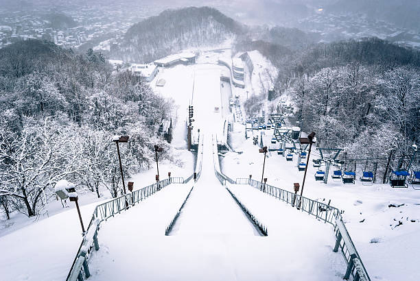 Ski jump at Okurayama, Japan Sapporo, Japan - March 11, 2015: Looking down the ski jump from the observation deck at Okurayama, home of the Winter Olympics in 1972 olympic city stock pictures, royalty-free photos & images