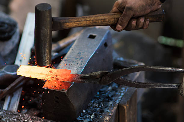 istock Blacksmith shaping a traditional Japanese cooking knife 605741514