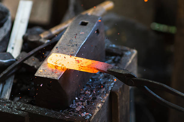 istock Blacksmith shaping a traditional Japanese cooking knife 605741564