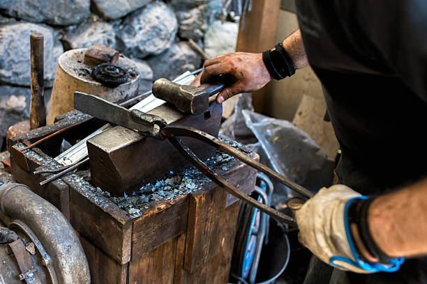 istock Blacksmith shaping a traditional Japanese cooking knife 605741796