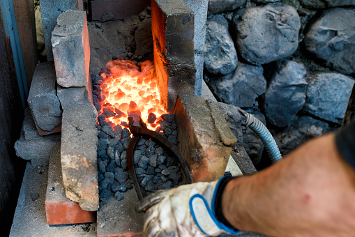 Blacksmith forging a traditional Japanese cooking knife. Kyoto, Japan. May 2016