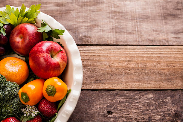 istock Organic colorful fruits, vegetables on rustic wooden table. 605742380