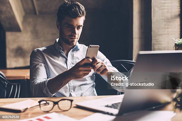 Texting To Colleague Stock Photo - Download Image Now - Smart Phone, Businessman, Mobile Phone