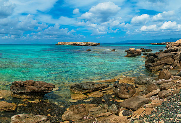 wild rocky beach at blue lagoon on sunny day on Akamas Peninsula near Latchi, Cyprus