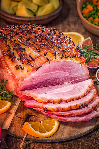 istock Glazed Holiday Ham with Cloves Served for Dinner 605743506