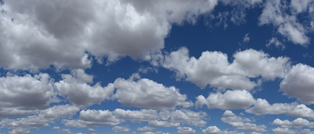 Cumulus clouds sit in the blue sky