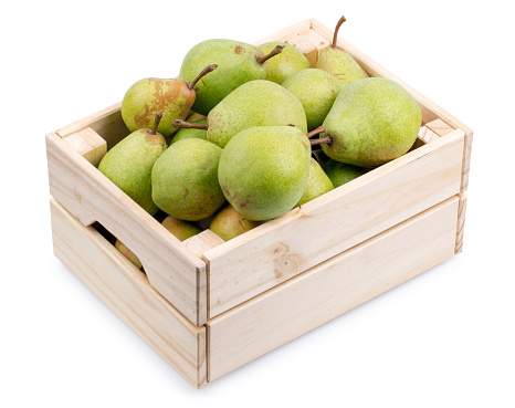 Wooden box full of fresh pears isolated on a white background