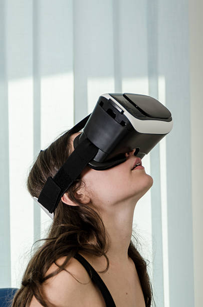 istock Girl have Fun with a Virtual Reality Simulator Headset 605745322