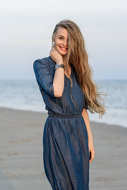 istock Young woman smile on the beach 605745510