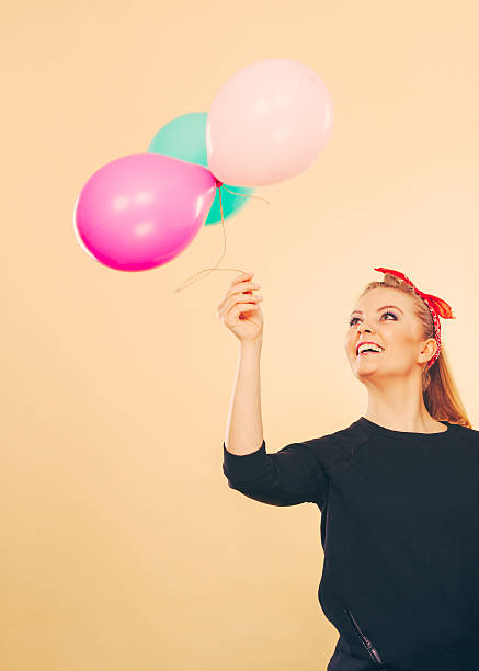 istock Happy smiling woman with balloons. 605746760