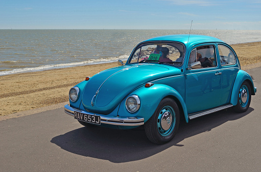Warwickshire, United Kingdom - April 7, 2016: Blue classic car Volkswagen Beetle parked at the street as seen from the front.