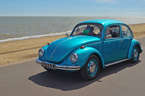 Classic Blue  Volkswagen Beetle Car Felixstowe, Suffolk, England - May 01, 2016: Classic Blue  Volkswagen Beetle Car  being driven along Felixstowe seafront promenade. beetle stock pictures, royalty-free photos & images