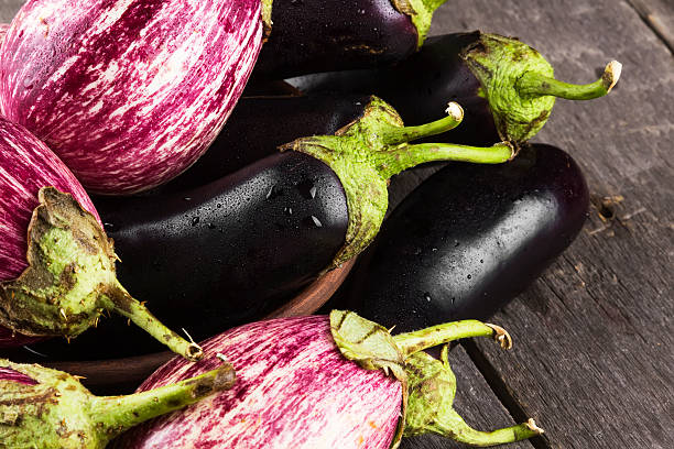 istock Various eggplants on a dark wooden background 605748296