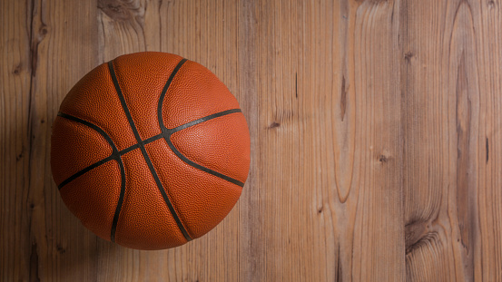 Basketball-ball on the floor indoors horizontal shot.