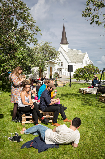 Traena, Norway - July 7, 2016: people chilling out having a drink during Traenafestival, music festival taking place on the small island of Traena