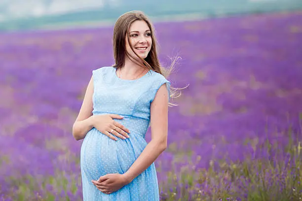 Photo of pregnant girl in a lavender field