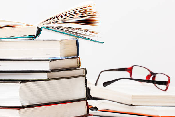 istock Books stacked glasses on the table 605752244
