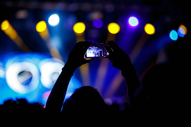 istock People makes photo with His smartphone on concerts 605752372