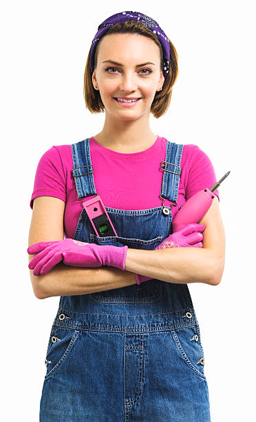 istock Woman holding cordless screwdriver on white 605753902