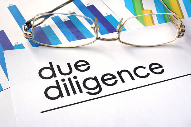 Paper with words due diligence and charts.