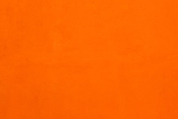 istock Vibrant Sicilian Wall Background: Bright Orange Stucco Texture 605756330