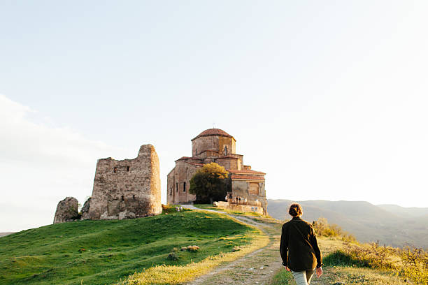 istock Girl on the background of  monastery 605756802