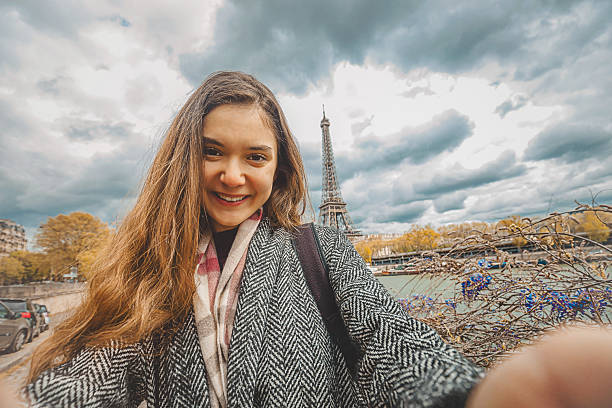 istock Young woman taking selfie with smartphone 605757654