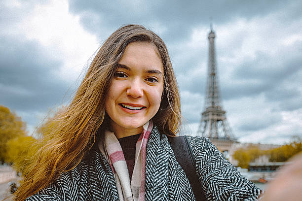 istock Young woman taking selfie with smartphone 605757792