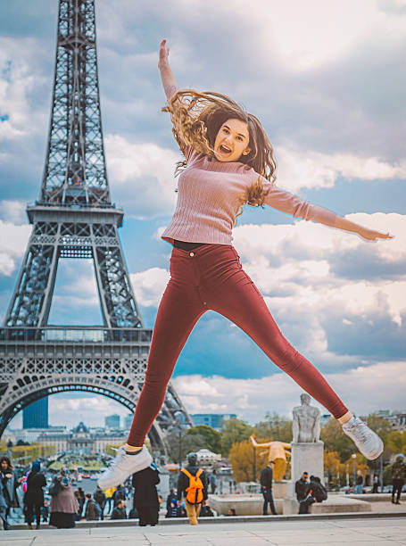 istock Young girl jumping against Tour Eiffel 605758544