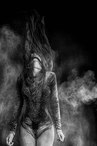 istock Young woman dancing in flour cloud 605761352
