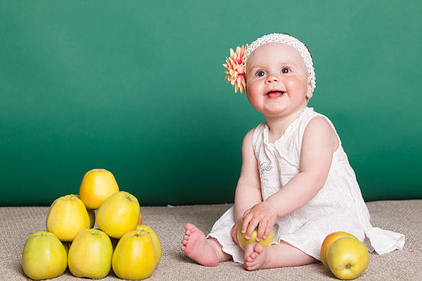 Portrait of a cute little girl eating an apple.