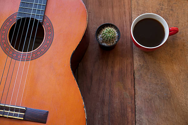 istock coffee cup and guitar on wooden table 605762502