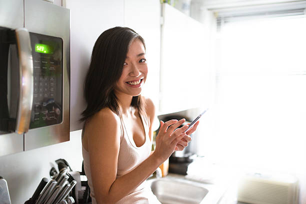 istock asian woman drinking a coffee on the kitchen 605762690