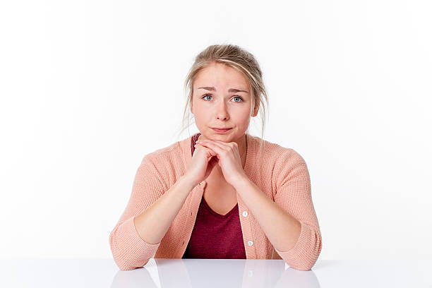 istock unhappy young blond woman sitting, apologizing and feeling sorry 605764536