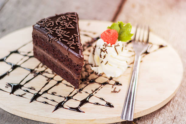 istock Tasty chocolate cake with berries on table close up 605766794