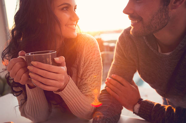 couple drinking coffee and talking. - coffee cafe drinking couple imagens e fotografias de stock