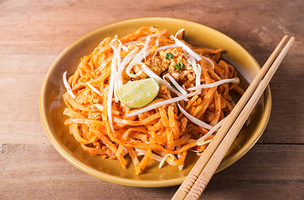 istock Fried Rice Noodles Topped With Pork 605772042
