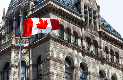Beautiful Canada flag is waving front of a historical building