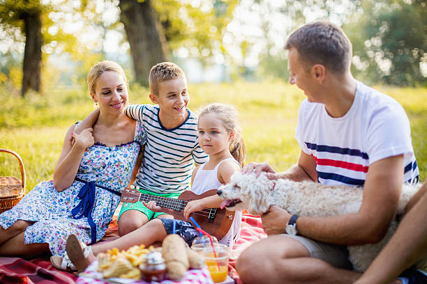 istock Cheerful happy family picnicking 605773040