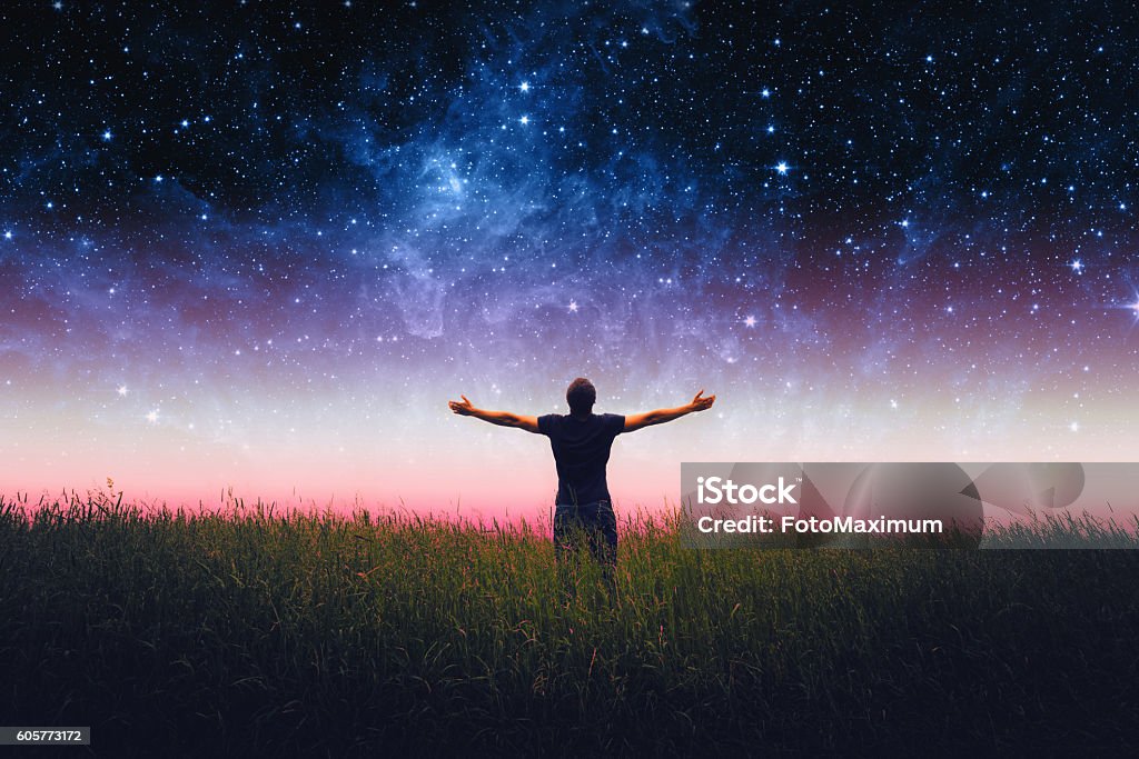 Man silhouette . Elements of this image furnished by NASA Silhouette of man and stars sky. Elements of this image furnished by NASA Arms Outstretched Stock Photo