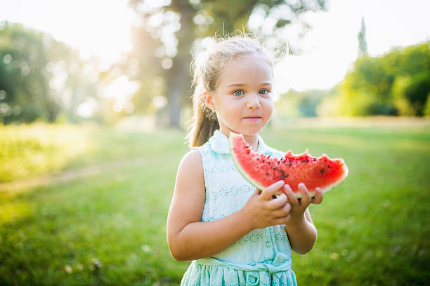 istock Little girl eating watermelon 605773698