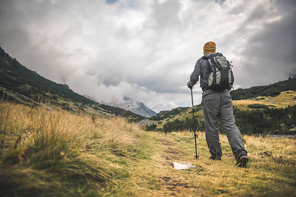 istock Traveler walking alone in the mountains 605776260