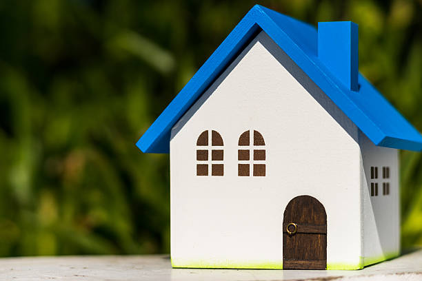 istock Home image, blue house toy under blue sky 605776266