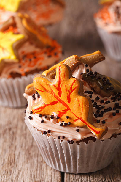 istock Beautiful cupcakes decorated with autumn leaves macro. vertical 605777734