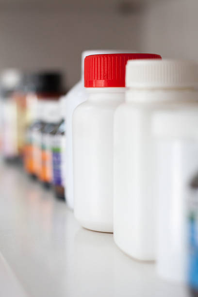istock bottles on pharmacy store shelf 605778180