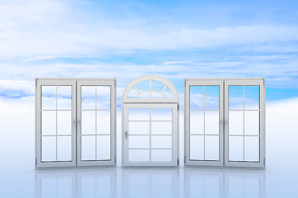 White windows with blue sky and clouds on background stock photo