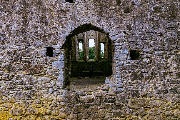 An empty window in the stone wall of an abandoned farmhouse