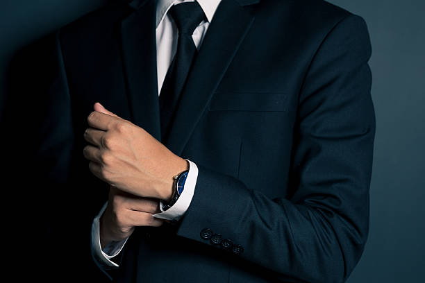 istock Businessman Fixing Cufflinks his Suit 605779792