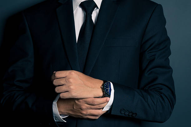 istock Businessman Fixing Cufflinks his Suit 605779826
