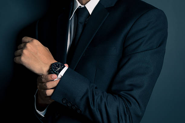 istock Businessman Fixing Cufflinks his Suit 605779868